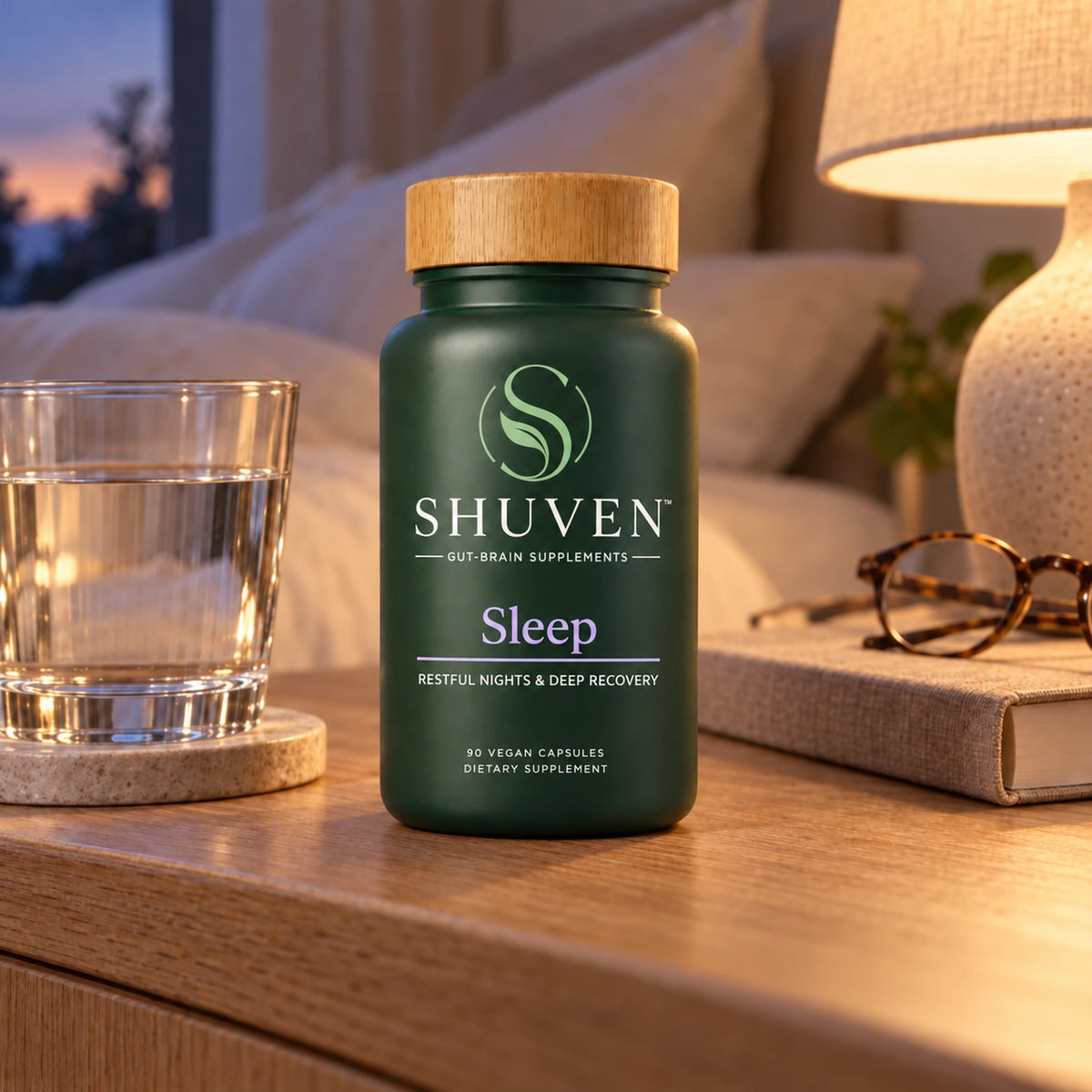 Shuven Sleep supplement bottle on bedroom nightstand with water glass and lamp